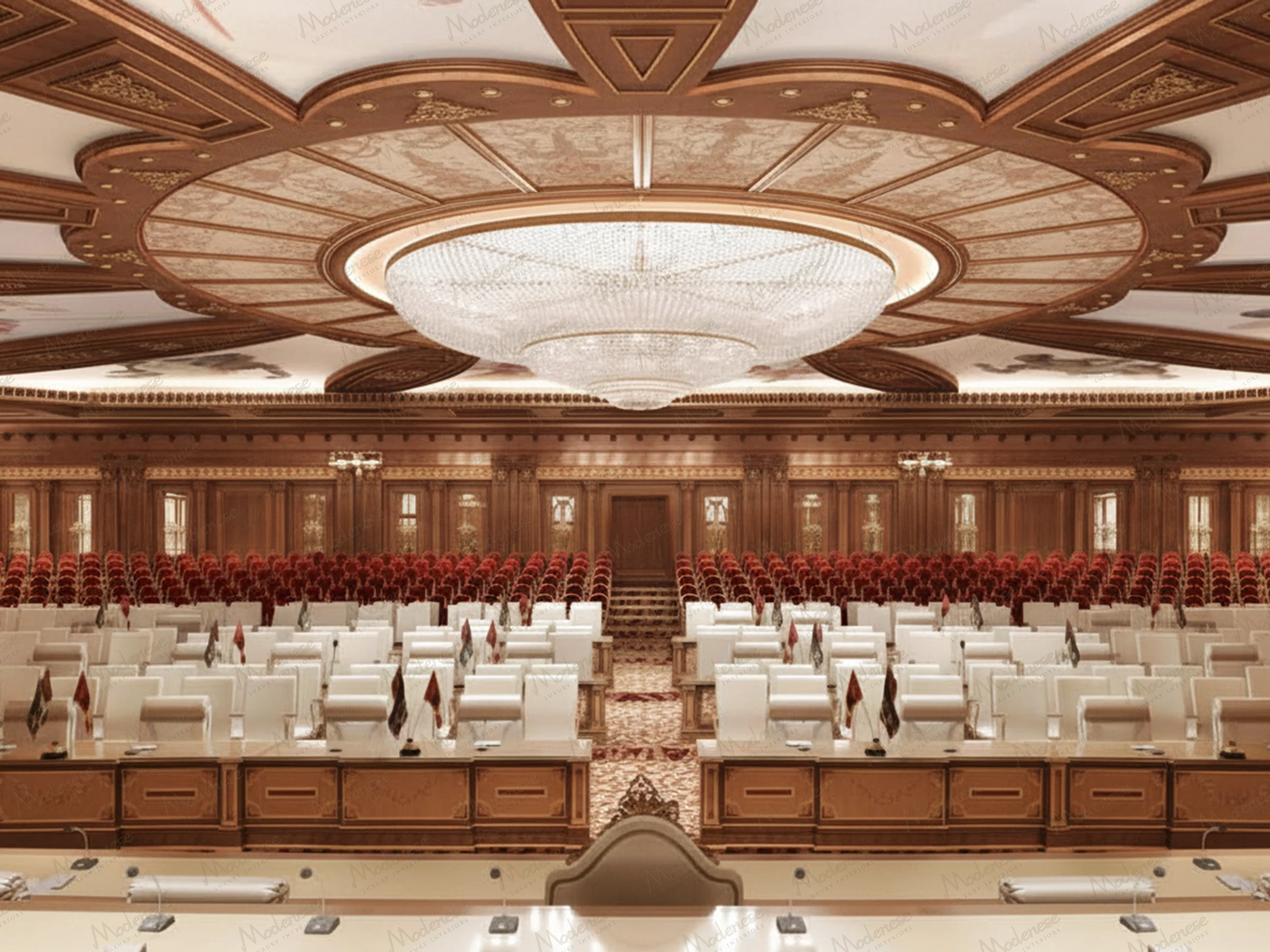 Lavish royal court affairs hall featuring a monumental crystal chandelier beneath an ornate ceiling, white leather official seating with country flags, and tiered red velvet audience chairs surrounded by finely carved wood paneling and classical decor