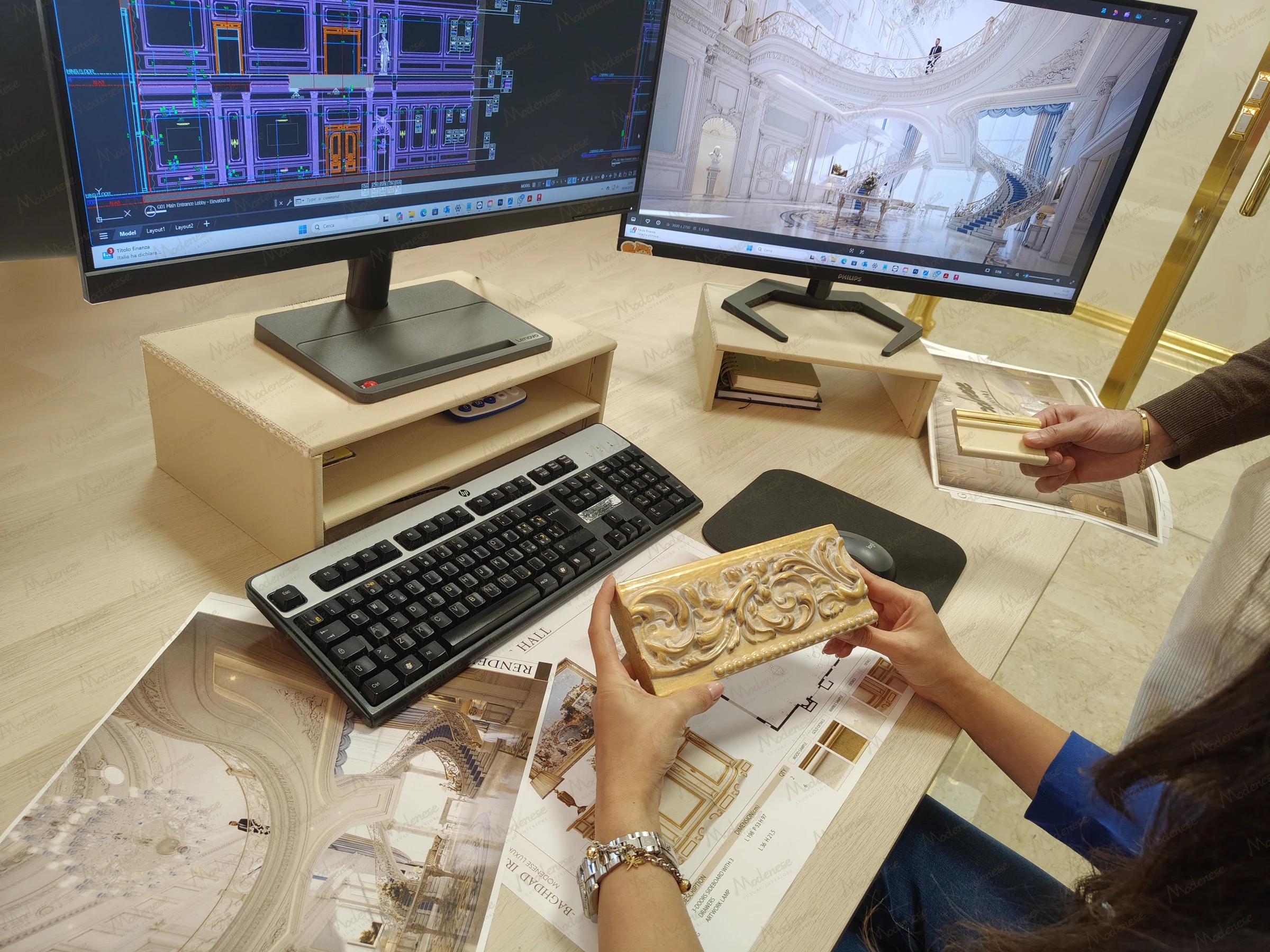 Interior design workspace in a Dubai villa project showing ornate trim samples, architectural plans, and dual monitors displaying CAD drawings and 3D renderings