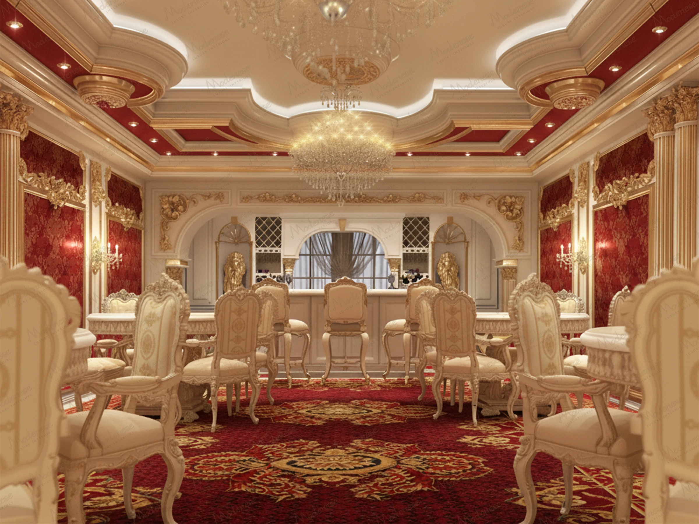 Regal tea lounge in Amman decorated with red damask walls, gold detailing, tufted cream chairs, and ornate ceiling moldings with chandeliers