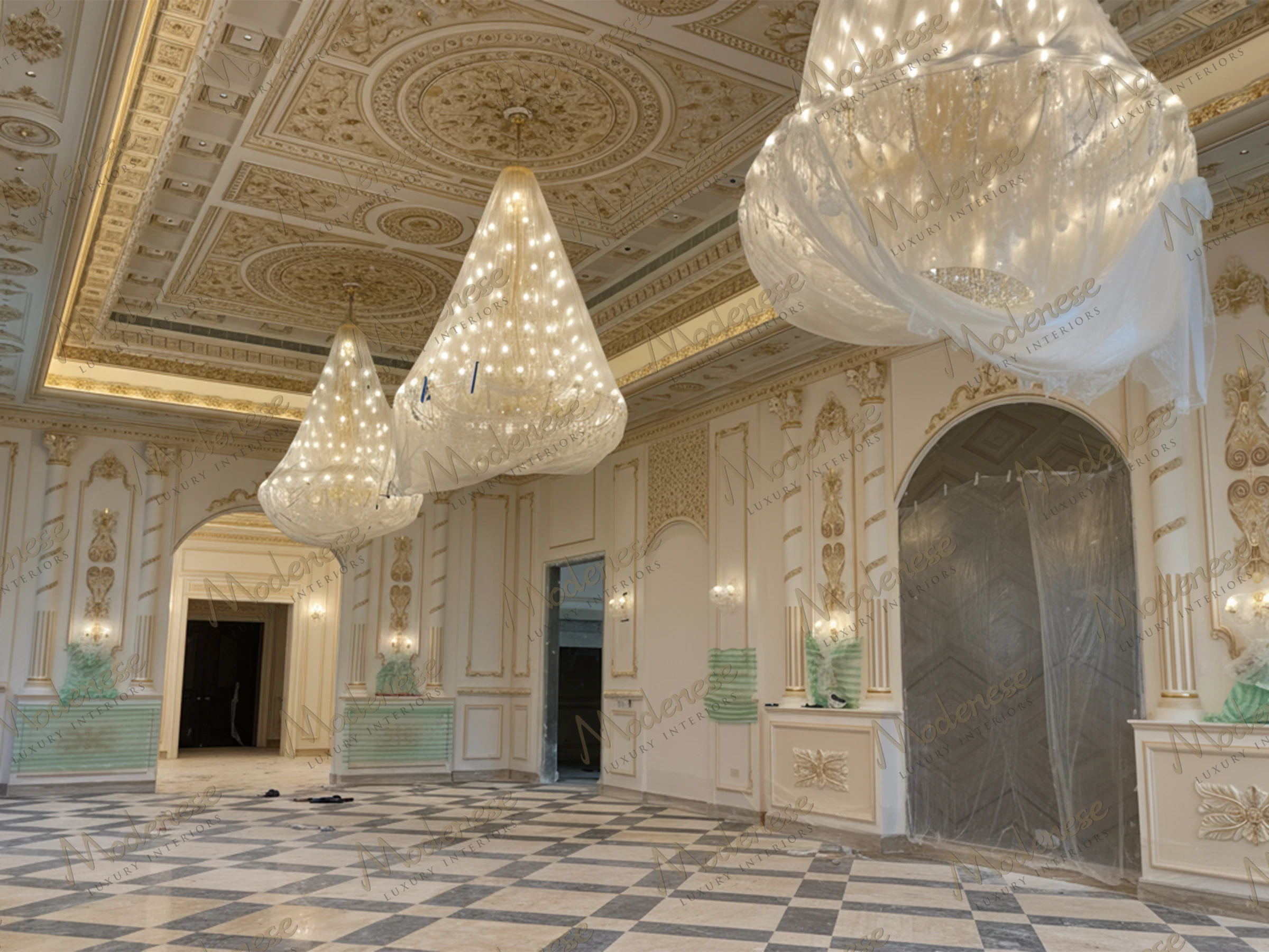 Opulent hall in Saudi Arabia King's Palace with large crystal chandeliers wrapped in protective plastic, intricate ceiling medallions, and marble flooring