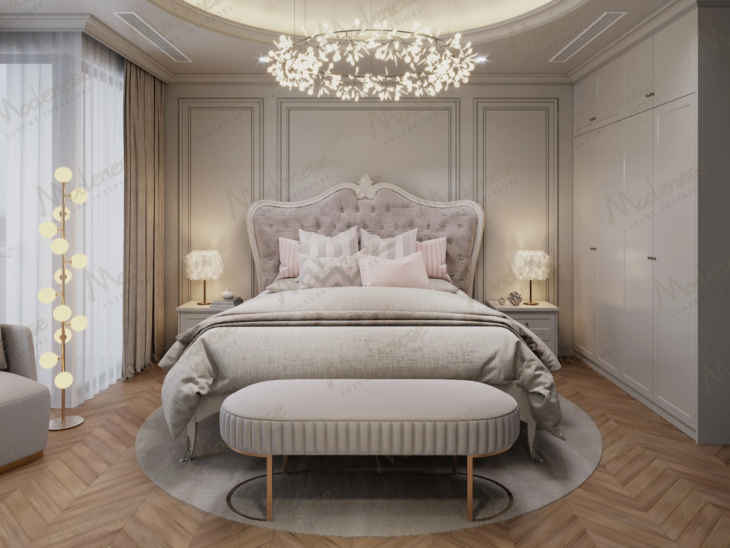 Elegant bedroom in Baghdad featuring a tufted velvet headboard, layered bedding with pastel pillows, circular recessed ceiling with chandelier, and soft ambient lighting